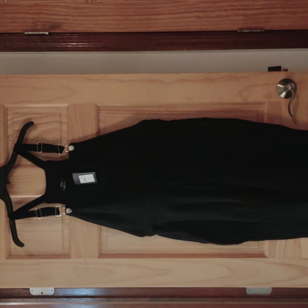 Black soft jumpsuit with back and side pockets; elastic leg bottoms
